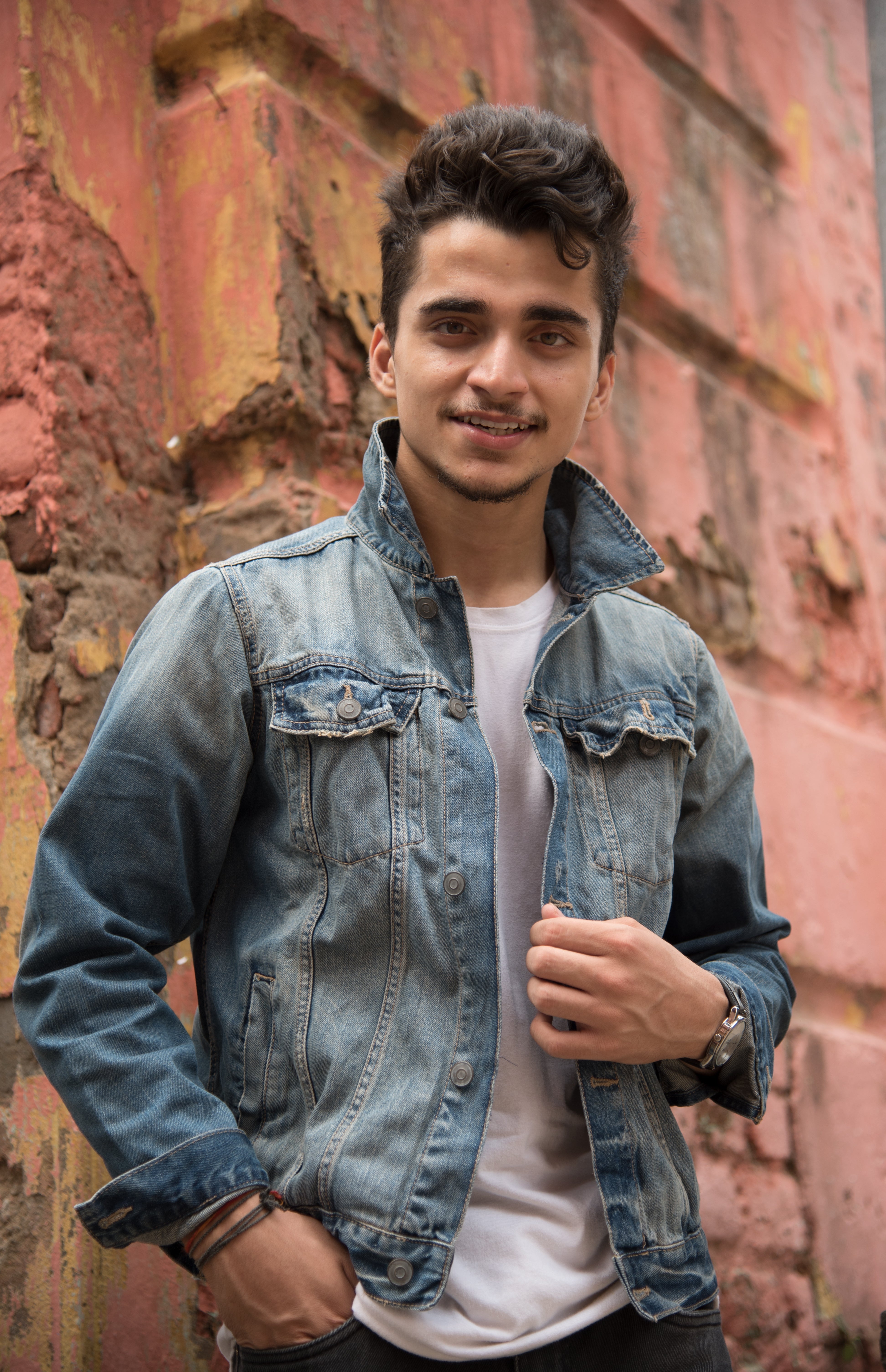 files/attractive-south-asian-male-posing-front-brick-wall-wearing-jean-jacket.jpg