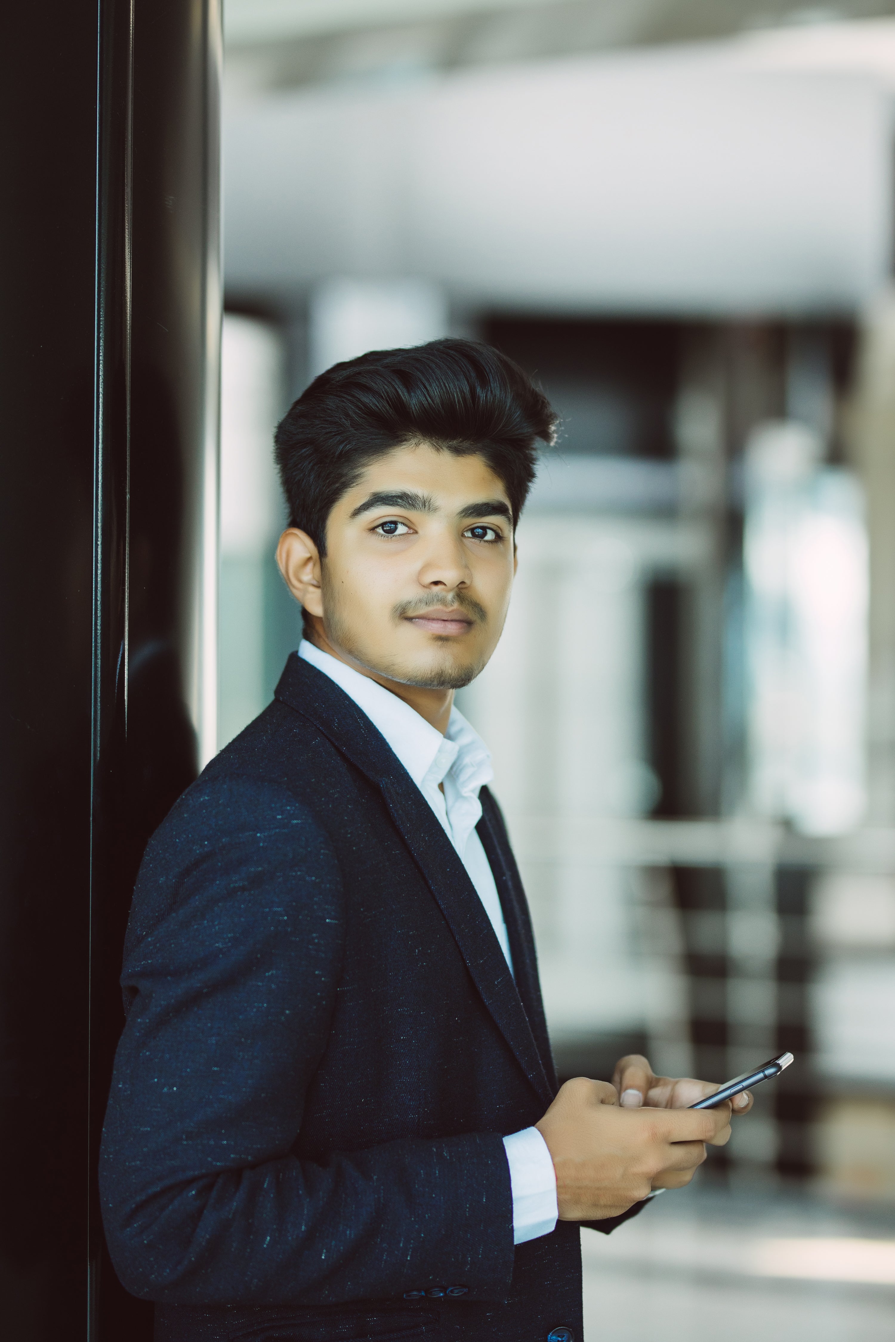 files/indian-business-man-reading-using-smart-phone-office.jpg